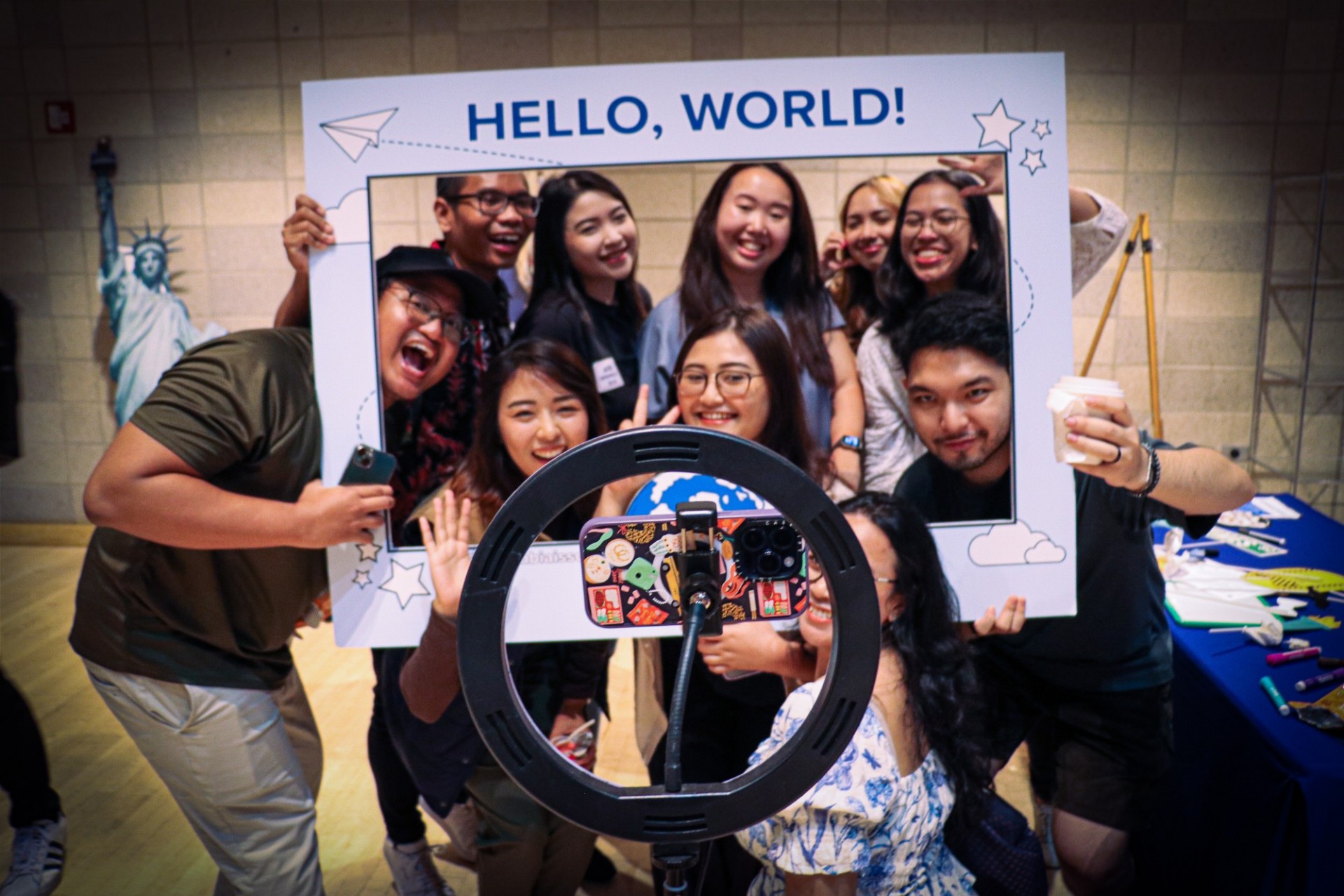 students taking selfie with hello world frame