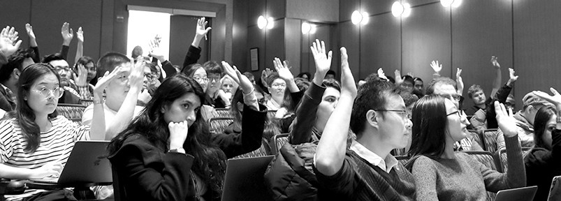 Students and Scholars raising hands