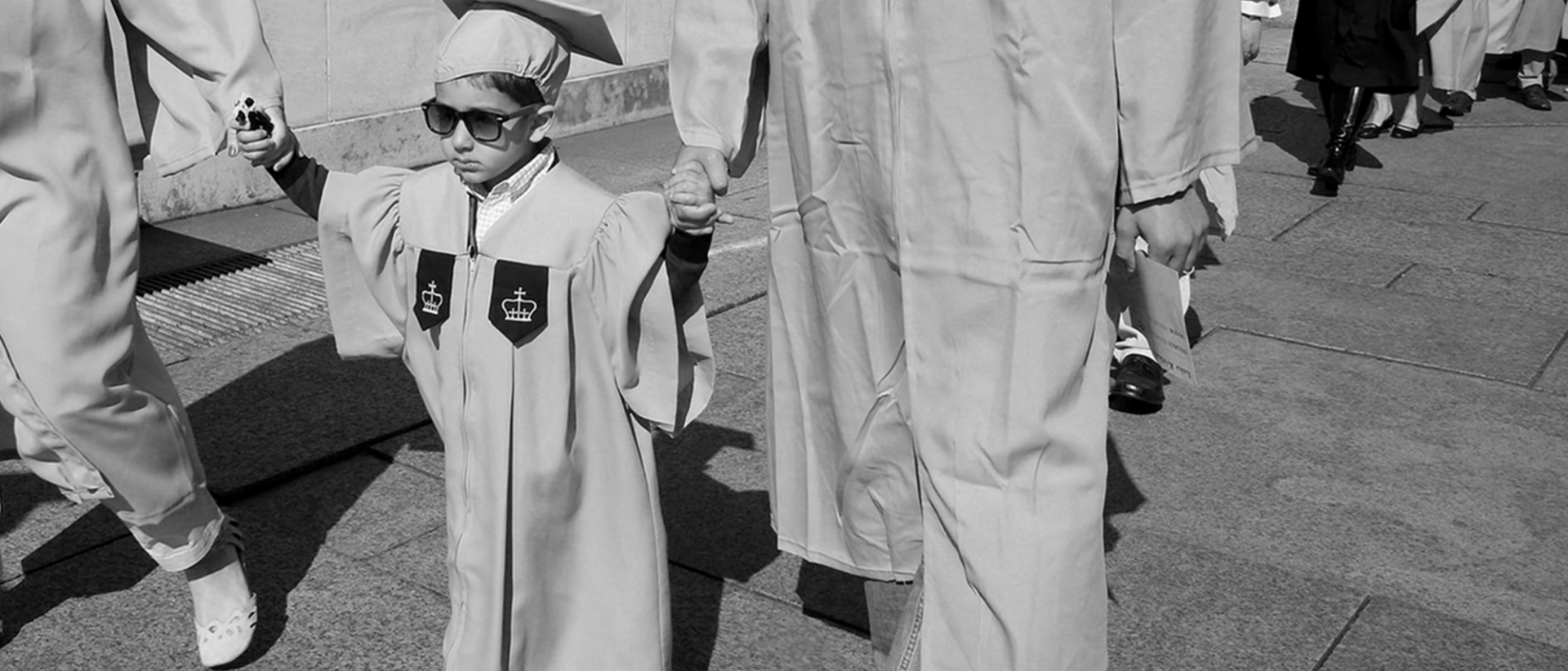 Child in graduation gown.