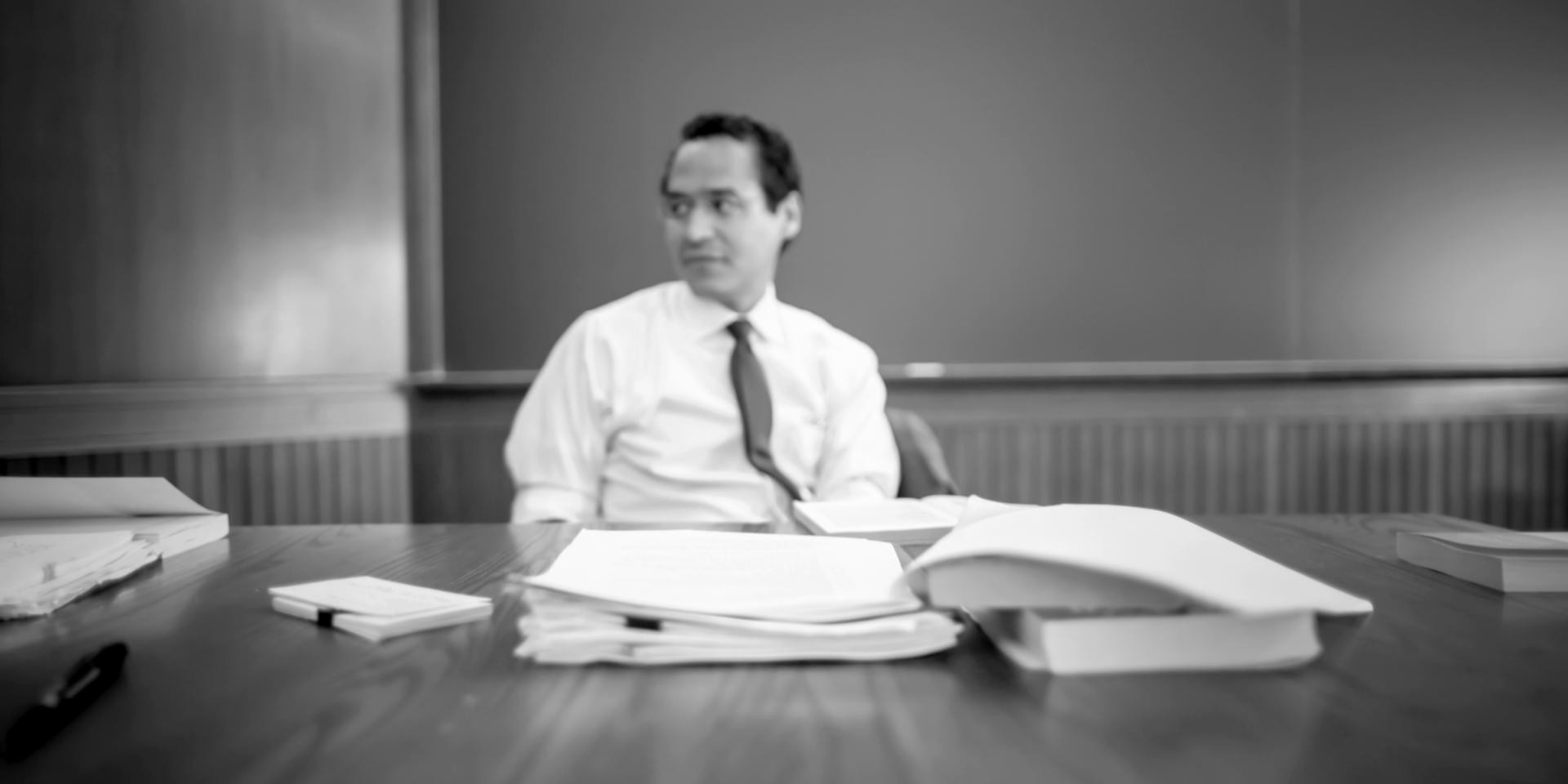 a person with paper and a book in front of them.